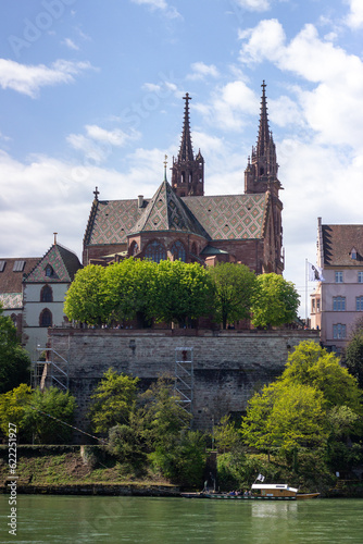 View of the Rhine River at Basel City in Switzerland. Famous longest Rhine River. Travel and business destination at the cultural city. View of Cathedral of Basler Münster. Red sandstone Cathedral. 