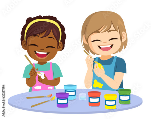 Two cute little children painting doing art activities. Kids using paint with brushes Back to school concept