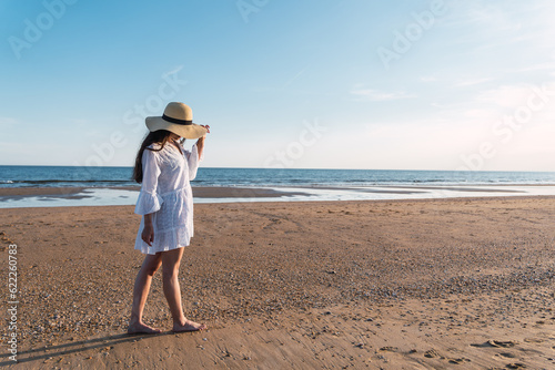 young woman walking on the beach