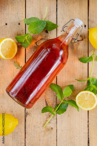 Red lemonade in white glass bottle photo