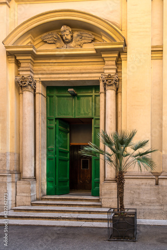 Church entrance door with a palm tree © OttoPles