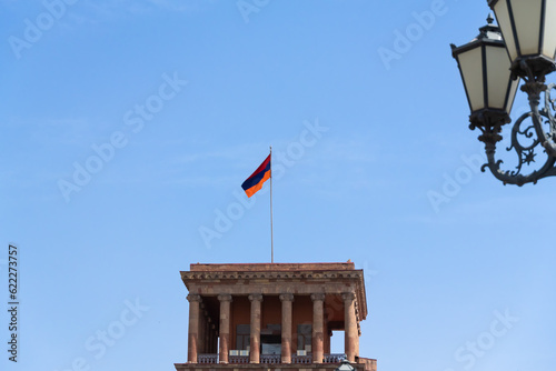 Close-up of the flag of Armenia against the blue sky on the building on Republic Square in Yerevan