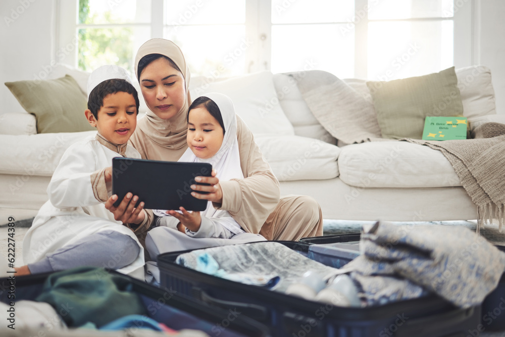 Travel, tablet and Muslim family with suitcase packing for holiday, vacation and religious trip. Home, luggage and mom with kids on digital tech and clothes in bag for journey, adventure and tourism Travel, tablet and Muslim family with suitcase packing for holiday, vacation and religious trip. Home, luggage and mom with kids on digital tech and clothes in bag for journey, adventure and tourism