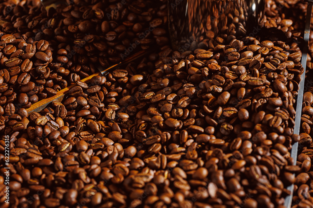 Process roasting coffee beans on professional mixing roaster machines, brown background top view Process roasting coffee beans on professional mixing roaster machines, brown background top view