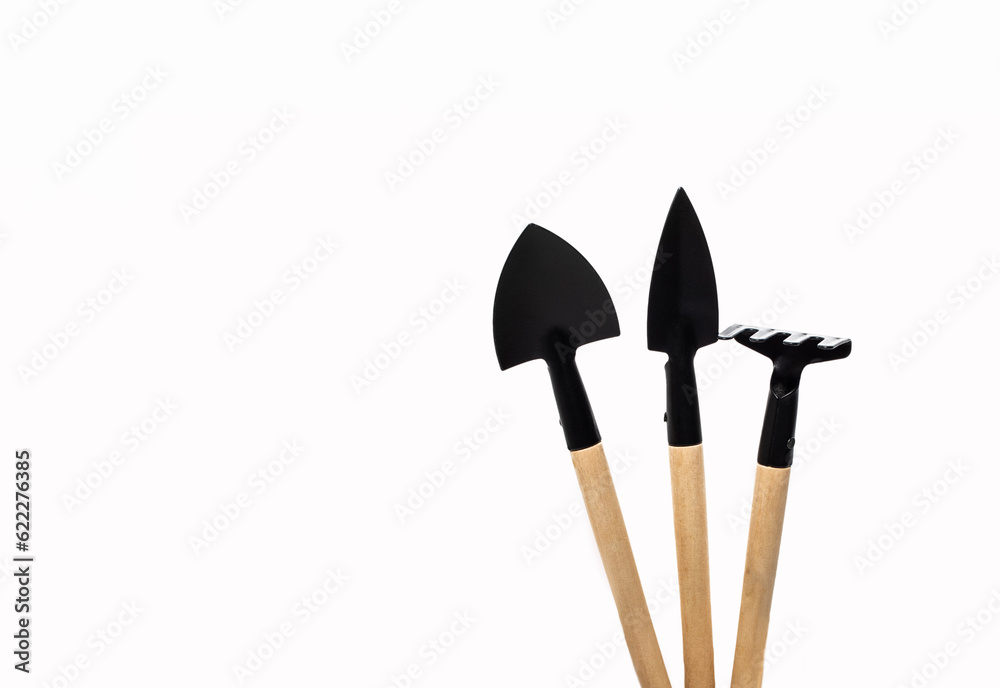 Wooden Gardening tools, shovel, rake on white background Wooden Gardening tools, shovel, rake on white background
