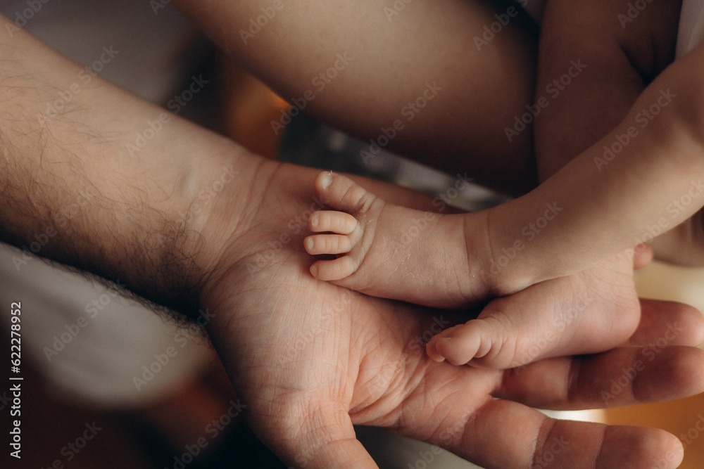 feet in hands, parent holding baby feet