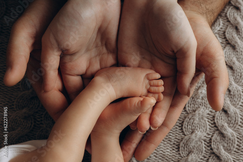 parent holding baby feet