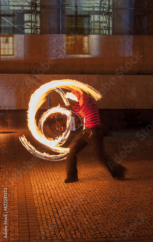 During the festival of lights in Berlin a man demonstrate his skills.