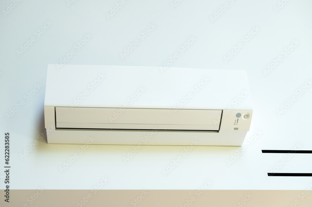 The air conditioner is hanging on the wall in the room The air conditioner is hanging on the wall in the room