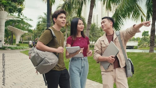 Medium long shot of students helping freshman to find university building in campus