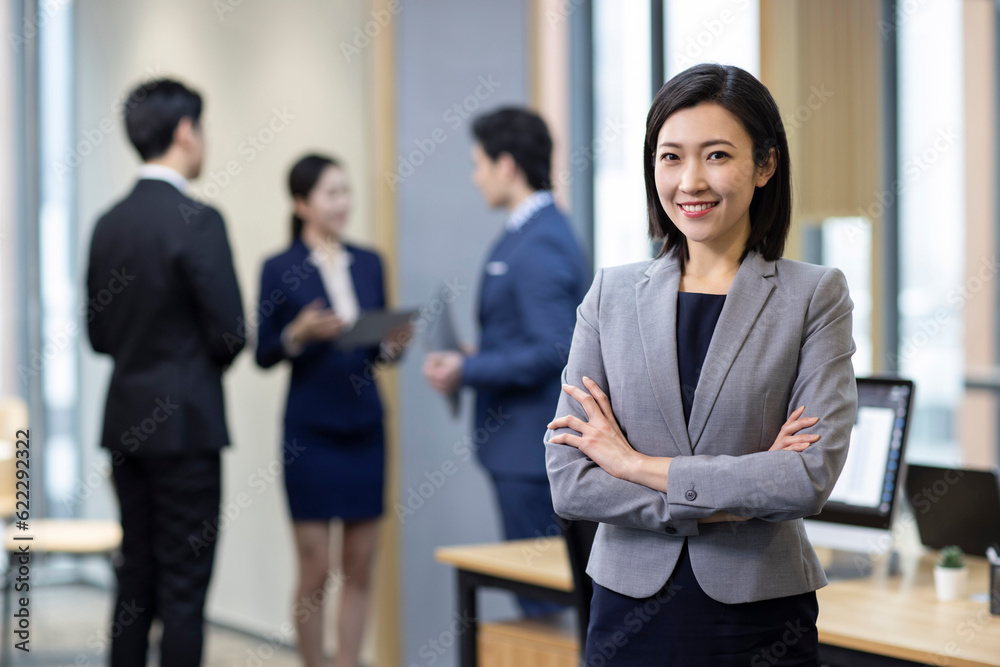 Portrait of cheerful Chinese businesswoman in office Portrait of cheerful Chinese businesswoman in office