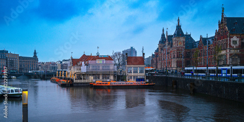 Amsterdam City Skyline, the marina of Open Havenfront Canal, and Central Station in rain in the Netherlands