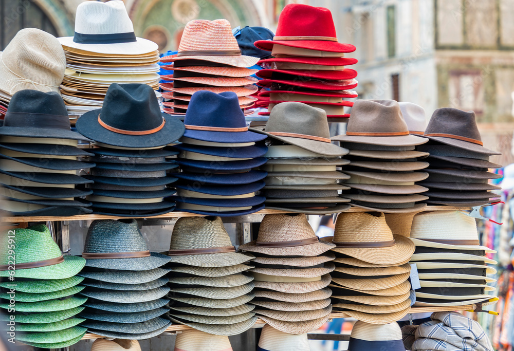 Different types of hats on display for sale at the market.