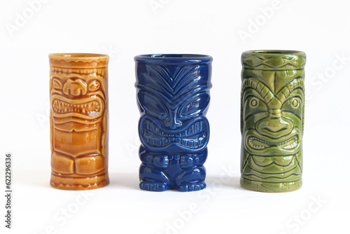 Studio photo of a set of three Hawaiian tiki glasses, Isolated on a White Background.