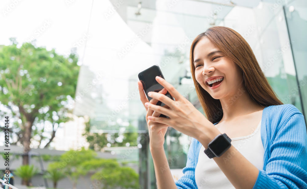 woman using smartphone in public areas, During leisure time. The concept of using the phone is essential in everyday life. woman using smartphone in public areas, During leisure time. The concept of using the phone is essential in everyday life.