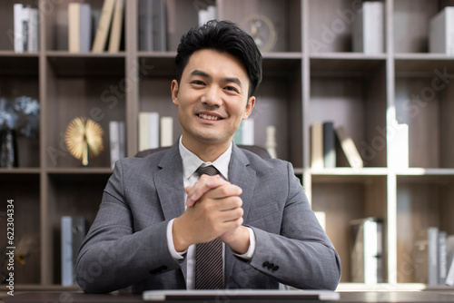 Successful Chinese businessman talking in office