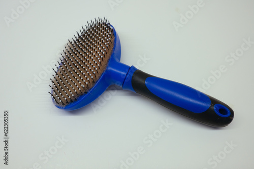 focus on cat hair brush which is placed on white color paper