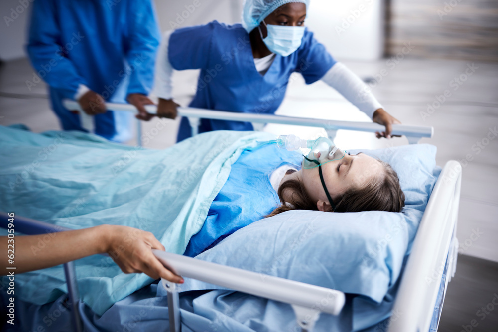 Hospital, bed and patient with doctors running in surgery, emergency and support for healthcare service. Theatre, surgeon and sick child with medical people or nurses in speed for crisis and problem Hospital, bed and patient with doctors running in surgery, emergency and support for healthcare service. Theatre, surgeon and sick child with medical people or nurses in speed for crisis and problem