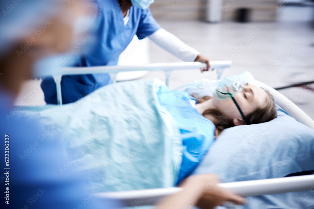 Obraz premium Hospital, bed and patient with surgeon running in surgery, emergency and support for healthcare service. Theatre, doctors and sick child with medical people or nurses in speed for crisis and problem