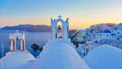 White churches an blue domes by the ocean of Oia Santorini Greece, a traditional Greek village in Santorini.