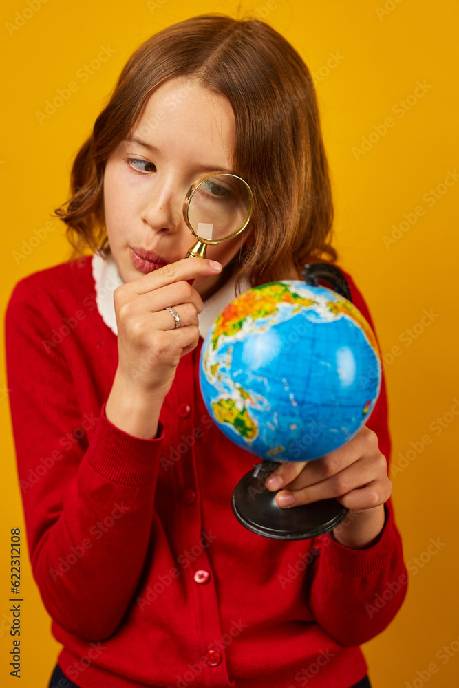 Stylish smiling school teenage girl holding magnifying glass in her hand Stylish smiling school teenage girl holding magnifying glass in her hand