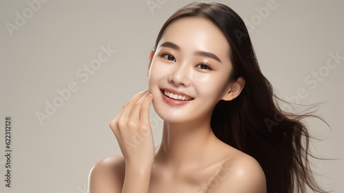 Beautiful Asian Woman with Perfect Skin Touching Her Skin After A Treatment. Dermatology, Spa, Skin Care Concept