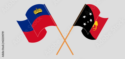 Crossed and waving flags of Liechtenstein and Papua New Guinea