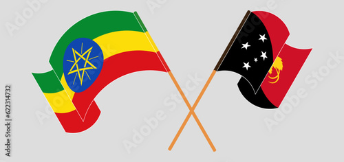 Crossed and waving flags of Ethiopia and Papua New Guinea