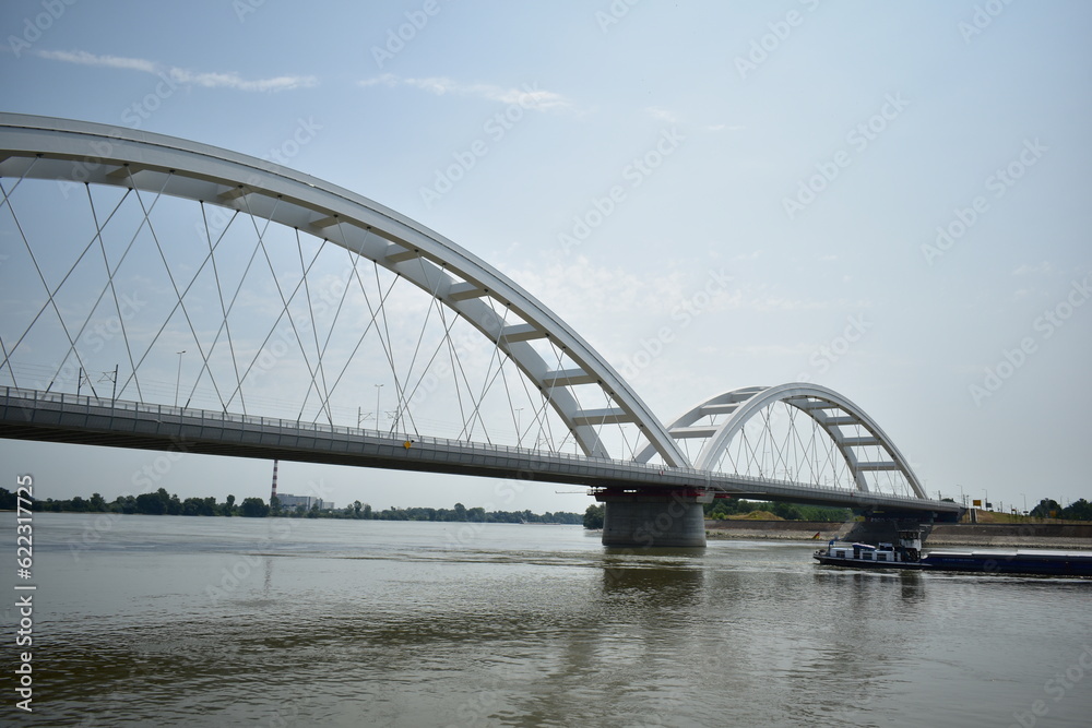 Naklejka premium ˝Novi Sad, Serbia - 07 11 2023: Žeželj Bridge and Danube river on a sunny day˝