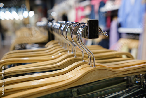 Lots of hangers in the clothing store. Selective focus. © Oleg Kozlovskiy