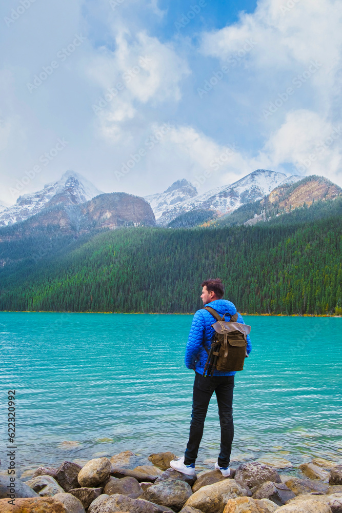Lake Louise Banff national park is a lake in the Canadian Rocky Mountains. Young men visiting Lake Louise during a vacation in Canada