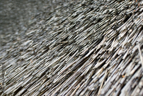 Close up straw wall texture background, old vintage thatched roof element.
