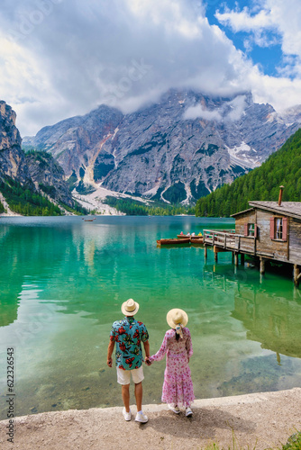 a couple visit Braies Lake Lago di Braies Italian Dolomites alpine lake Italy, Europe, men, and women visit Lago Di Braies during summer vacation in Europe