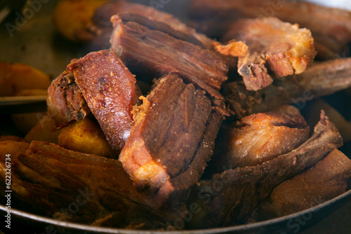 Pork chicharrón is a traditional food in Peru. Pork fat is used to cook the meat and consists of frying the skin of the pig with or without meat. photo