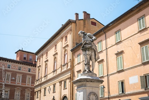 Monumento a Luigi Galvani statue in Bologna, Italy in a sunny day with historic houses
