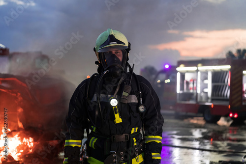 Portrait of a heroic fireman in a protective suit. Firefighter in fire fighting operation. © .shock