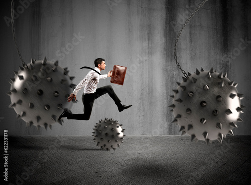 Businessman between fierce spiky balls that hinder