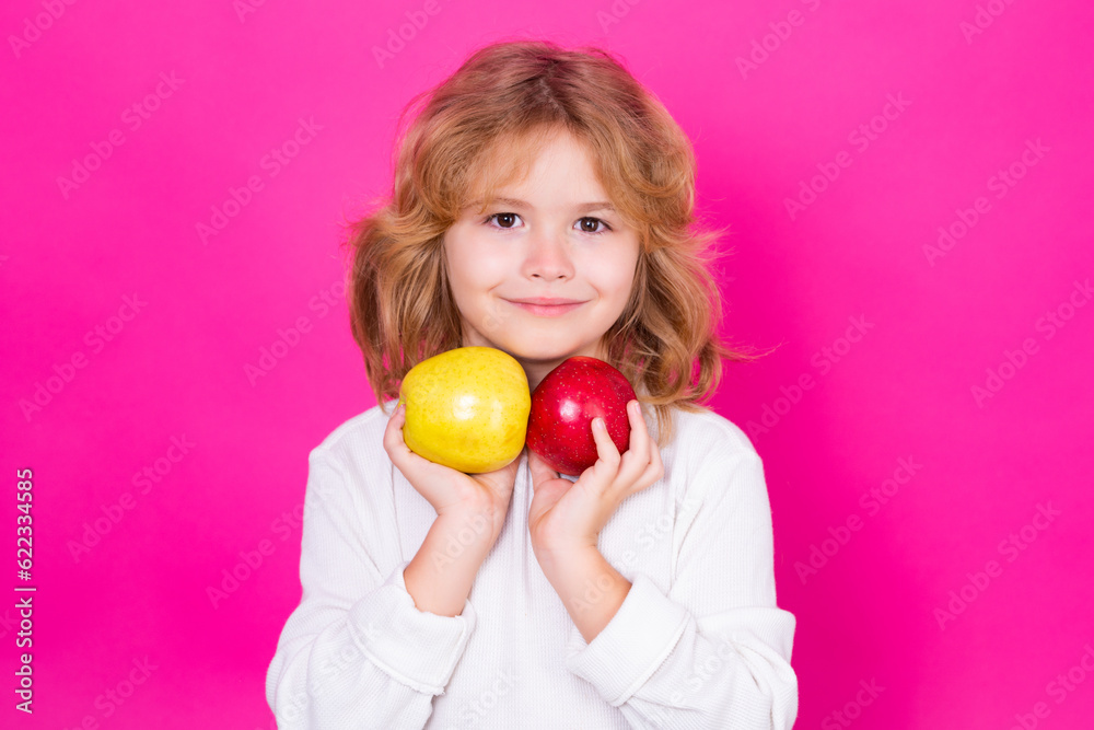 Kid with apple in studio. Studio portrait of cute child hold apple isolated on pink background. Kid with apple in studio. Studio portrait of cute child hold apple isolated on pink background.