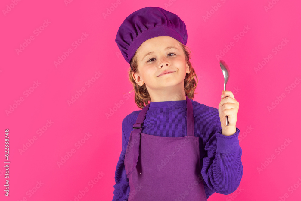Child cook hold spoon. Child chef cook, studio portrait. Kids cooking. Teen boy with apron and chef hat. Child cook hold spoon. Child chef cook, studio portrait. Kids cooking. Teen boy with apron and chef hat.