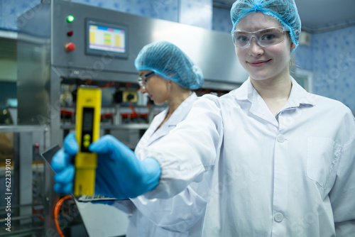 Portrait of confident female researcher carrying out scientific experiment in drink water laboratory