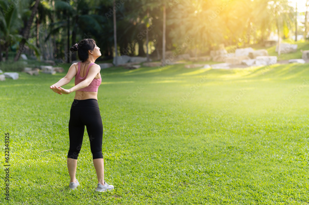 Female jogger. Get inspired fit active image of Asian young woman in pink sportswear stretching muscles in park before run, enjoying healthy outdoor activity. Wellness and fitness in natural setting. Female jogger. Get inspired fit active image of Asian young woman in pink sportswear stretching muscles in park before run, enjoying healthy outdoor activity. Wellness and fitness in natural setting.
