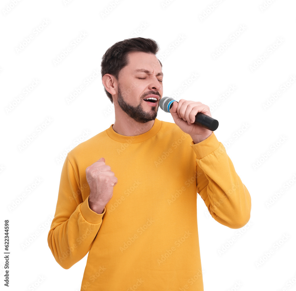 Handsome man with microphone singing on white background