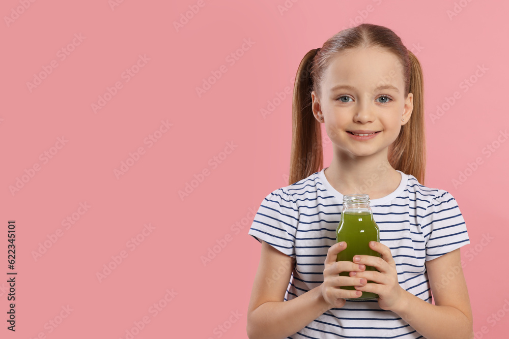 Cute little girl with bottle of fresh juice on pink background, space for text Cute little girl with bottle of fresh juice on pink background, space for text
