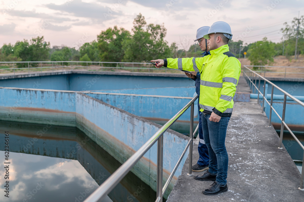 Environmental engineers work at wastewater treatment plants,Water supply engineering working at Water recycling plant for reuse,Technicians and engineers discuss work together.