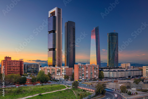 Image of Madrid, Spain financial district with modern skyscrapers during sunset. photo