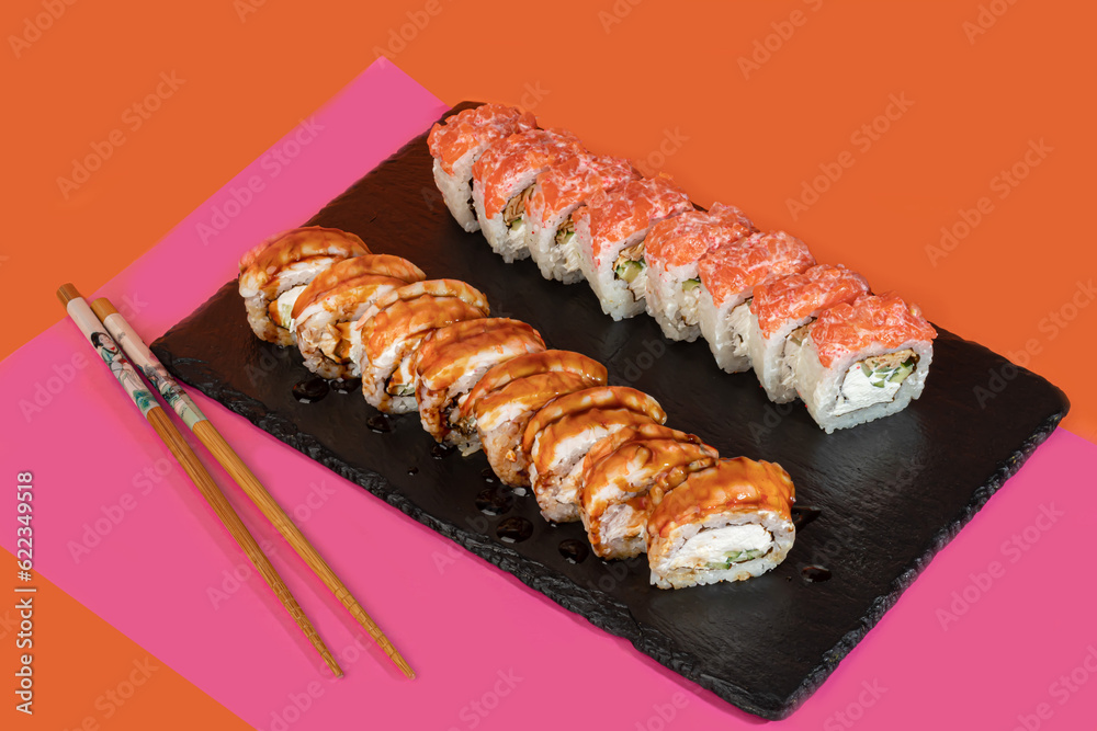 Sushi sets, rolls with caviar, shrimp, tuna and avocado and Philadelphia cheese, on a white plate. Sushi sets, rolls with caviar, shrimp, tuna and avocado and Philadelphia cheese, on a white plate.