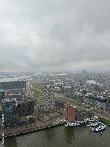 Picturesque view of city with modern buildings and harbor on cloudy day