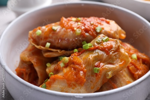 Delicious stuffed cabbage rolls cooked with homemade tomato sauce in bowl, closeup