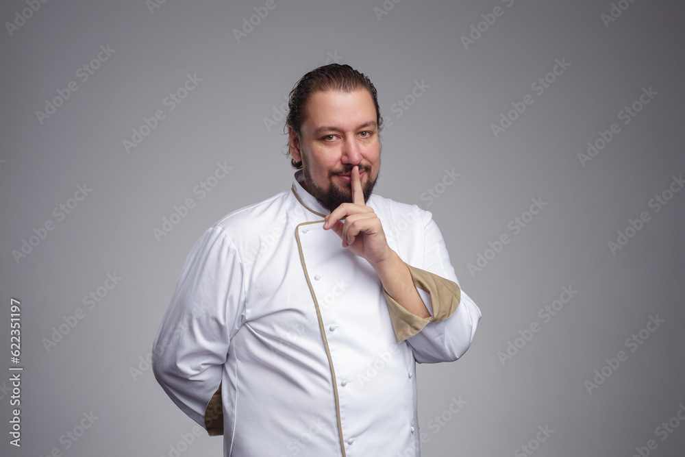 Chef (cook) keeps a secret about the ingredients. The index finger to his lips. Chef (cook) keeps a secret about the ingredients. The index finger to his lips.