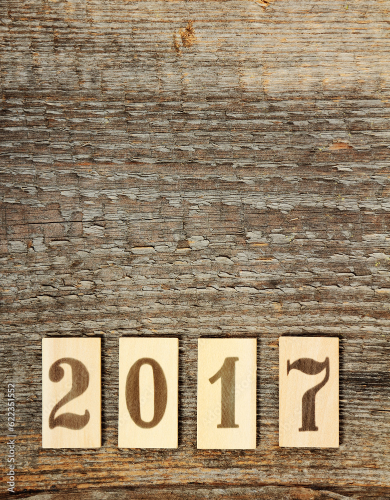 Numbers 2017 on old brown wooden background Numbers 2017 on old brown wooden background